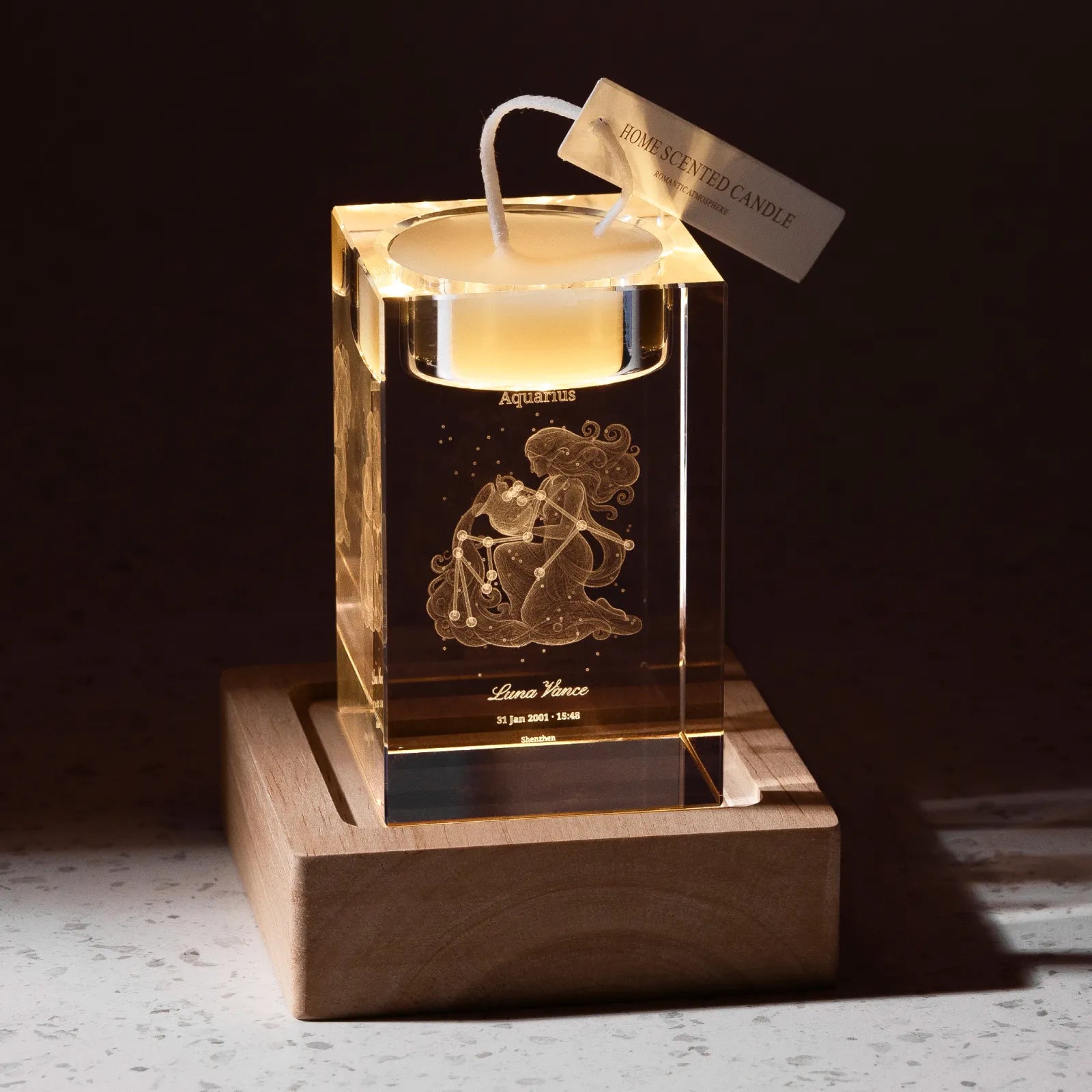 Crystal memorial candle holder engraved with a portrait and remembrance text, candle lit