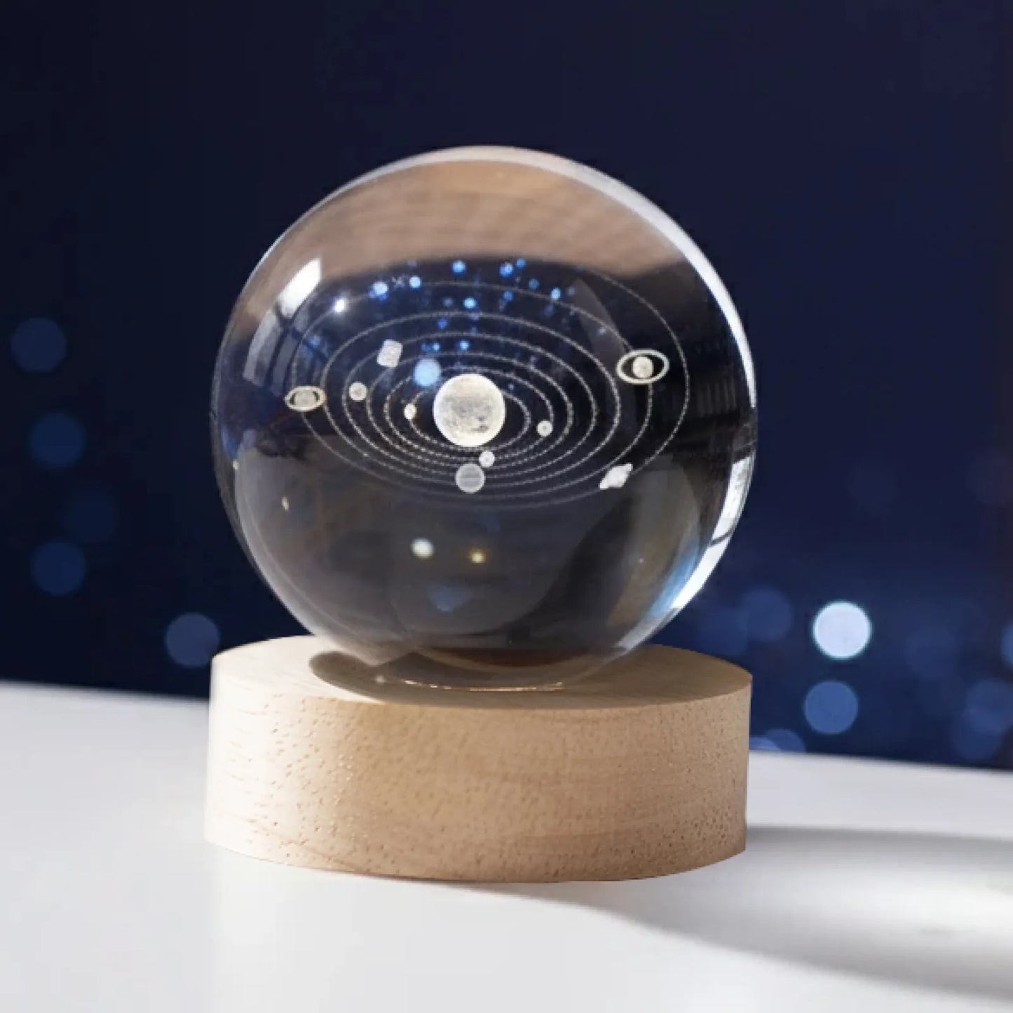 Crystal sphere with 3D engraved solar system on a wooden LED base