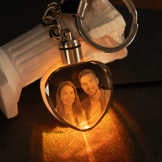 Heart crystal keychain engraved with a couple's photo, glowing warm